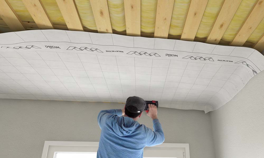 Man putting up membrane on the cealing