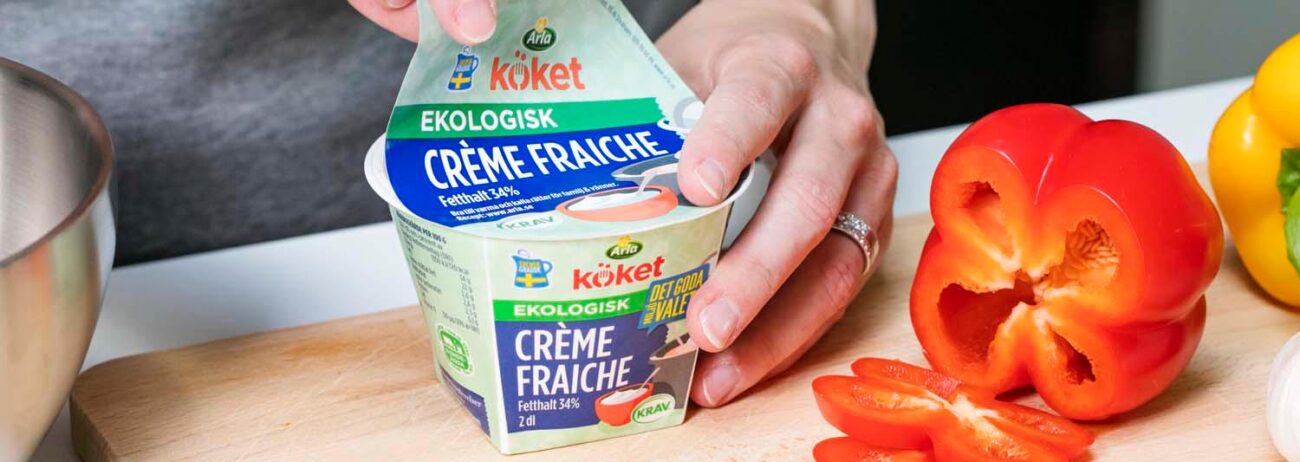 Opening lid on a Arla Creme Fraiche cup